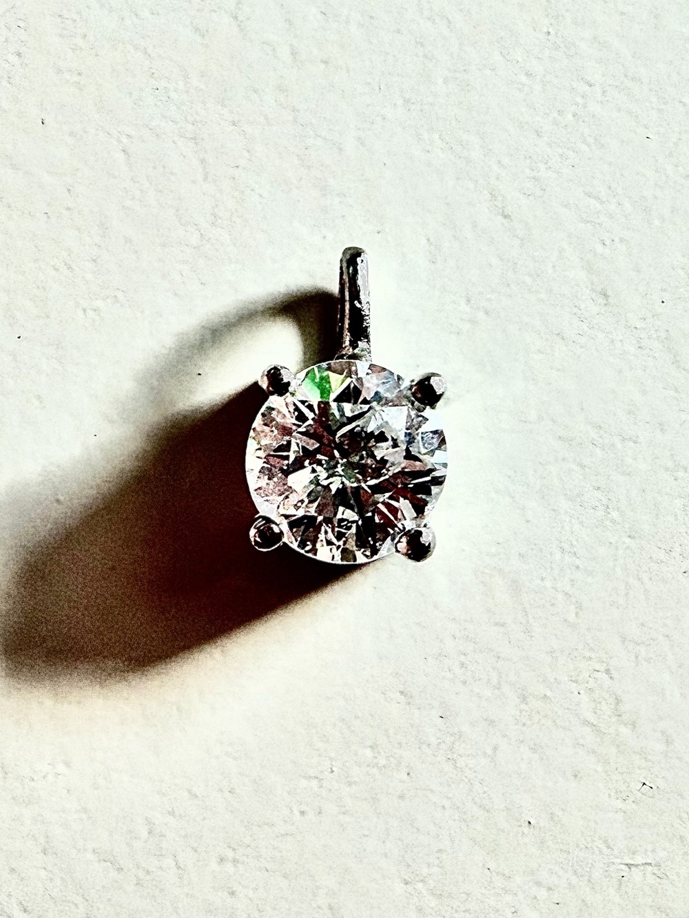 Solitaire diamond 0.642  set in Platinum for necklace.  color F, S1-2 beautiful
